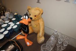 A vintage jointed Teddy bear and a Daffy Duck figu