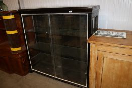 A painted display cabinet having glass sliding doo