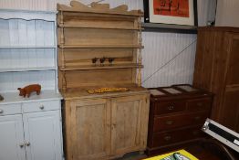 A stripped pine dresser raised on cupboard base