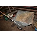 A galvanised garden wheelbarrow