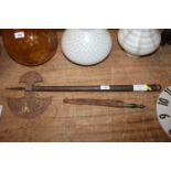 An Eastern Axe and a brass handled dagger. This item can only be purchased by someone over the age