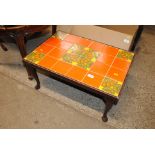A tile top coffee table on cabriole supports