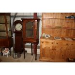 An antique walnut corner cabinet on stand