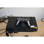 A Sony Playstation2 together with one remote control - sold as seen