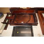 A mahogany Butlers tray; a pie crust bordered tray and a lacquered tray on folding stand