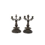 A pair of bronze three light candelabra, with raised mask and garland decoration, probably later