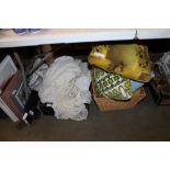 Two boxes containing various cushions and linen