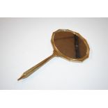 An enamel decorated dressing table hand mirror