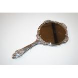 A silver mounted dressing table hand mirror