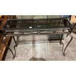 A black metal framed glass top console table,
