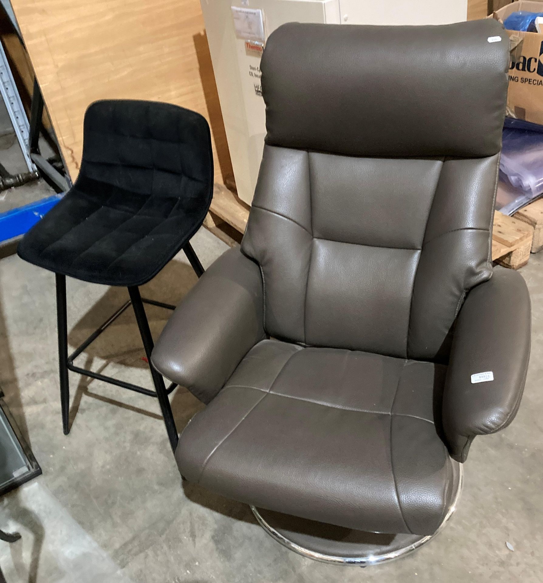 A brown leather-finish swivelling recliner chair on chrome base,