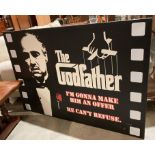 A large framed 'The Godfather' box print,