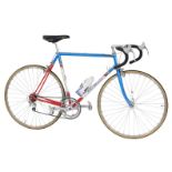 An Eddy Merckx bicycle, with a red, blue and white Columbus SL frame, with applied labels and