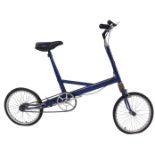 A Moulton bicycle, the royal blue frame with a black seat, lacking pedals, on a single bicycle