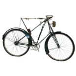 A late 19thC Dursley Peterson bicycle, the green painted frame with a cream woven and sprung seat,