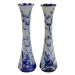 A pair of early 20thC Moorcroft Florian ware vases, of slender waisted form, decorated in the Violet