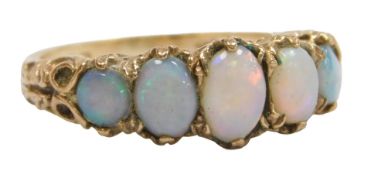 A 9ct gold and opal five stone ring, set with graduated oval cabochons, in a claw setting, size L,