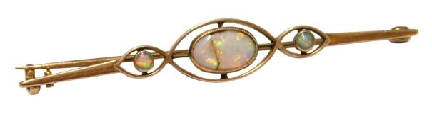 An Edwardian opal three stone bar brooch, in an openwork design, yellow metal, unmarked, 3.3g.