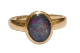 A 9ct gold and opal ring, the single opal in an oval box setting, size N1/2, 2.7g.