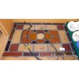 A stained glass leaded panel, in clear and amber coloured glass, 36cm x 52cm.