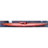 A full size fibreglass slalom canoe, named 'Harry', orange with black trim, with a paddle.