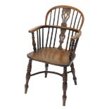 A 19thC yew and elm low back Windsor chair, with pierced Nottinghamshire style splat, raised on