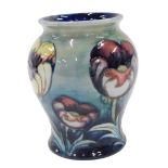 A Moorcroft pottery Multicoloured Poppy pattern vase, of bellied circular form, on green ground,