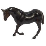 A late 19thC cast bronze sculpture of a standing horse, with one front leg raised, 12.5cm high.