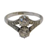 An Art Deco diamond ring, set with two old round-cut stones of 5.2mm diameter each, split