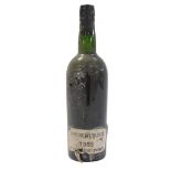 A bottle of Cockburns 1963 vintage port, with a seal and partial paper label.