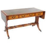 A Regency style burr walnut drop leaf sofa table by N Norman Ltd., the top and drop leaf sections