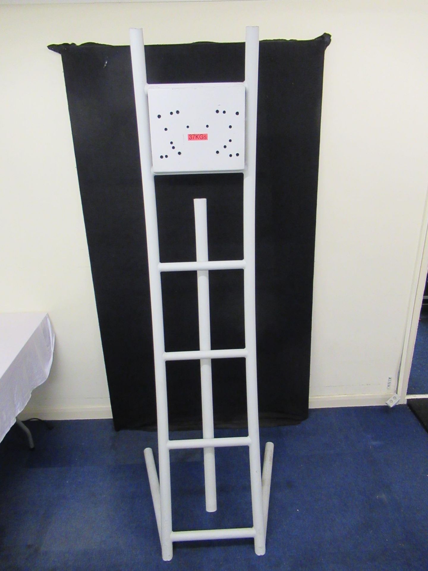 White tubular steel screen stand