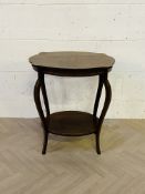 with a cartouche shaped top, with an oval under tier below and raised upon shaped cabriole