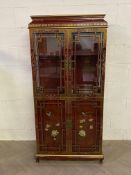 A decorative contemporary Chinese chinoiserie style lacquered four door cabinet