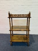 A small Victorian figured walnut and marquetry inlaid three tier wotnot