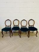 A set of four elegant 19th century walnut framed balloon back chairs