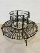 An attractive vintage patinated metal tree bench