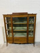 An Edwardian mahogany breakfront display cabinet with a bevelled glass central door