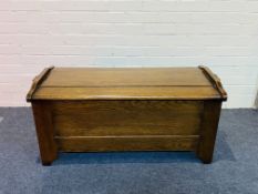 An oak blanket chest with carved arcaded decoration to the front