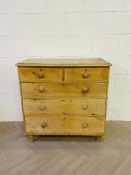 A 19th century waxed pine chest of drawers