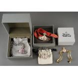 Four pieces of boxed and loose Vivienne Westwood costume jewellery, comprising a pink leather dog