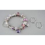 A Pandora bracelet and a pair of non-designer modern earrings. The pandora bracelet with a