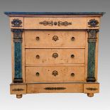 A 19th century Empire style marble topped satin birch chest of three drawers, applied mask and