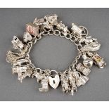 A white metal charm bracelet. Desinged as a solid curb link chain with padlock clasp (padlock