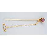 An ornate French late 19th century 18ct gold garnet and diamond stickpin. Set with a garnet, rose