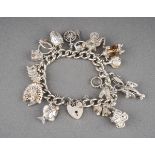 A 925 Sterling silver charm bracelet with heart shaped lock with fourteen white metal charms
