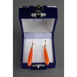 A pair of coral earrings. Each ear pendant suspending a tapering coral drop, with plain polished