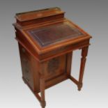 A late 19th century walnut and satinwood banded Davenport, the raised back with brass grille to