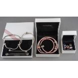 A collection of Pandora items. To include two bracelets, one bangle, two safety chains, a pink