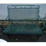 An Edwardian style green painted metal two seater rocking chair, approx 105cm wide [1]
